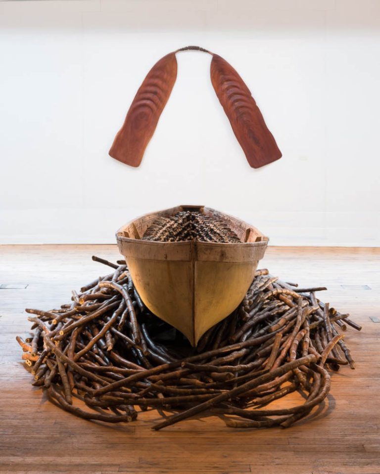 THEIR SPIRITS GONE BEFORE THEM, 2006, cottonwood canoe, 1357 resin figures, sugar cane, 16’; OAR FOR BA (Soul), 2010, mahogany, furniture fragments, 50 x 80in