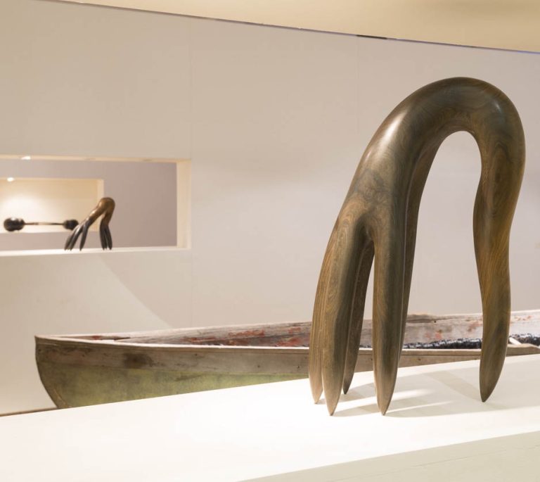 Foreground: ECSTATIC, 2010, lignum vitae | Background: DAUGHTER OF COMB, 2010, bronze, WEIGHING OF THE HEART, 2009, cedar and furniture fragments, 2009, 7" x 31" x 11"