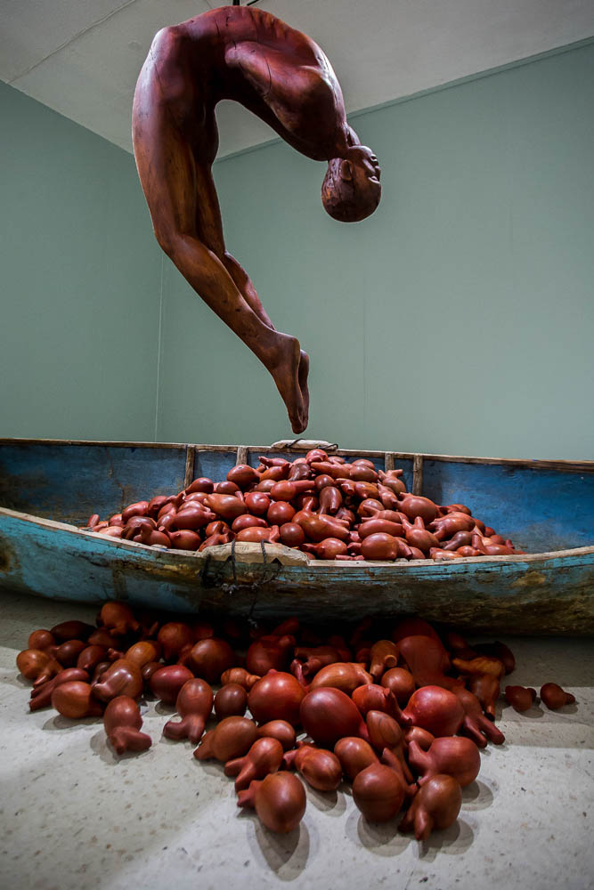 HEART OF A MAN, 2019, wood and fiberglass canoe, cedar and mahogany hearts, rope, metal, 18’ x 18’